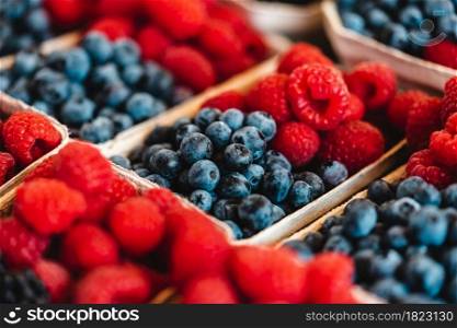 Organic raspberries and blueberries on a farmers market