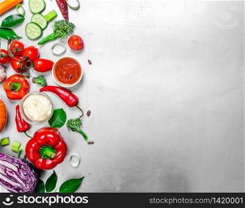 Organic raw vegetables. Fresh raw vegetables with herbs and green leaves. On the steel background .. Fresh raw vegetables with herbs and green leaves.