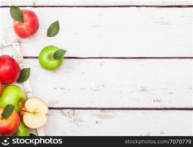 Organic red and green apples on wooden background.