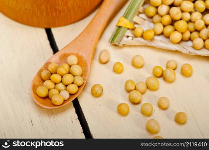 organic soya beans over rustic wood table macro closeup