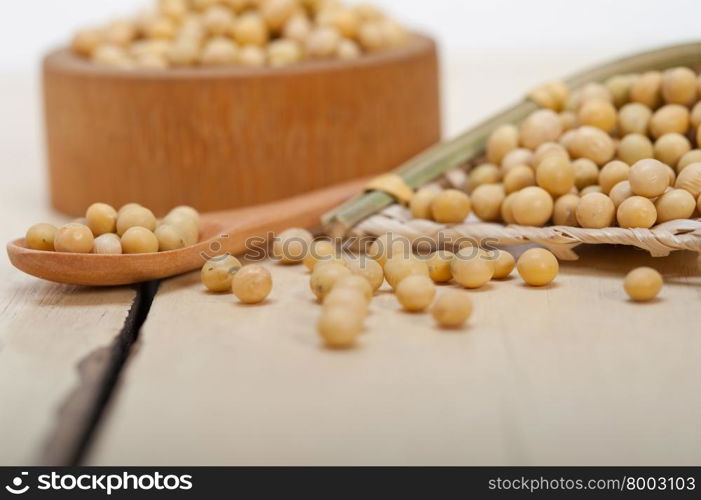 organic soya beans over rustic wood table macro closeup