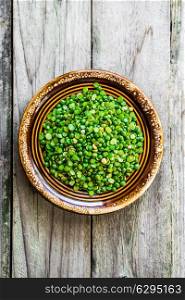 Organic split peas on wooden background