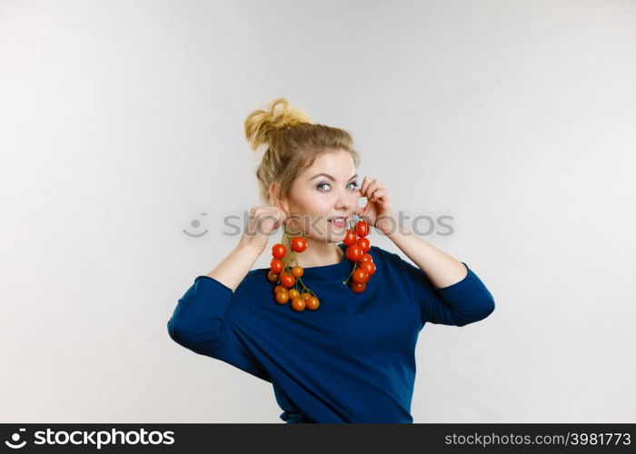 Organic vegetables and food concept. Happy positive smiling woman holding fresh cherry tomatoes. Woman holding fresh cherry tomatoes
