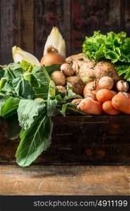 Organic vegetables box on old wooden background