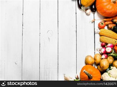 Organic vegetables. Different raw vegetables . On a white wooden background.. Different raw vegetables .