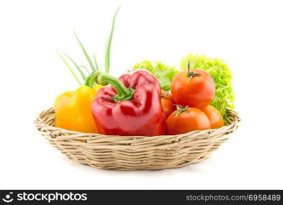 Organic vegetables in the wicker basket on white background