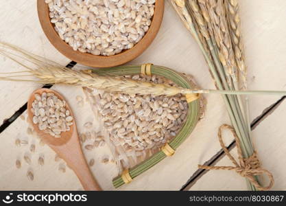 organic wheat grains over rustic wood table macro closeup