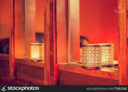 Oriental candles on wood, colorful arabic texture dark background. romantic design. Oriental candles on wood, colorful arabic texture dark background.