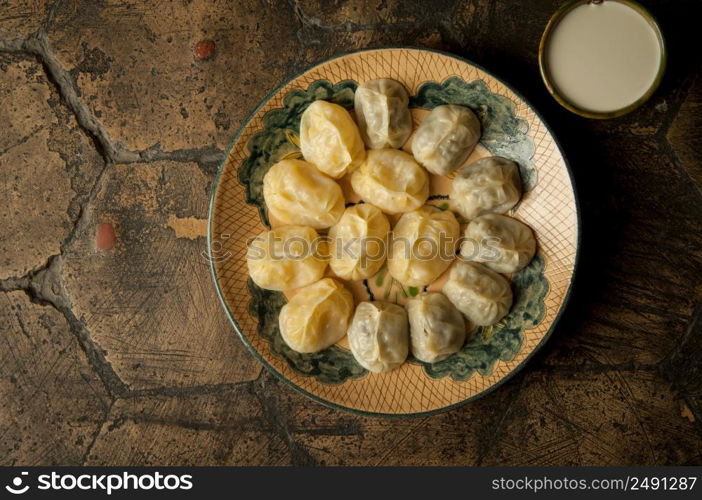 oriental dishes on decorative old tiles. meat in a test on a decorative old paving stone. meat dish on an old paving stone