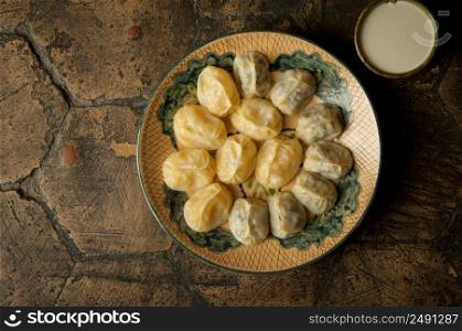 oriental dishes on decorative old tiles. meat in a test on a decorative old paving stone. meat dish on an old paving stone