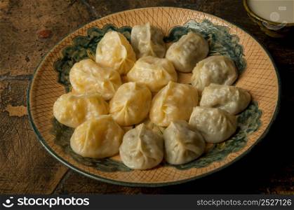 oriental dishes on decorative old tiles. meat in a test on a decorative old paving stone. meat dish on an old paving stone