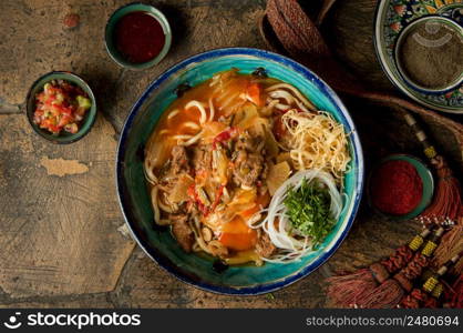 oriental dishes on decorative old tiles. noodles and spices with braid on decorative old paving stones. meat dish on an old paving stone