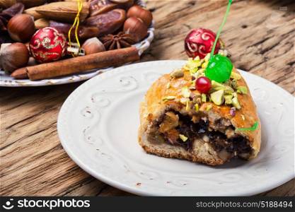 oriental fruit cake. piece of cake with dates, fruits and nuts on a saucer