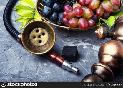 oriental hookah with grapes. Exotic smoked shisha with tobacco with a taste of grapes