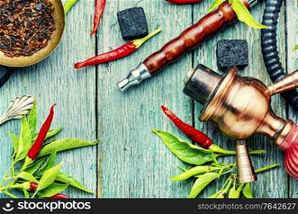 Oriental hookah with tobacco aroma of red hot pepper. Hookah with chilli pepper flavor.. Smoking shisha with chili