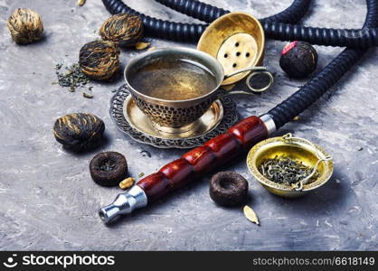 Oriental shisha hookah with aroma tea for relax.Shisha and tea. Hookah with aroma tea