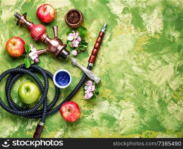 Oriental smoking hookah. Arabian shisha with apple. Hookah with apple.Fruit smoking hookah. Shisha with apple tobacco
