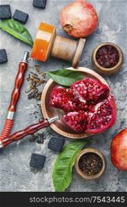 Oriental smoking hookah.Pomegranate flavor hookah.Fruit tobacco shisha. Modern hookah with fruit