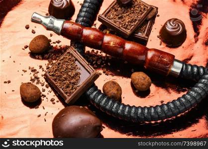Oriental smoking hookah with a taste of chocolates. Chocolate tobacco flavor.. Shisha hookah with chocolate