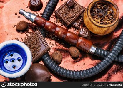 Oriental smoking hookah with a taste of chocolates. Chocolate tobacco flavor.Summer party,. Tobacco hookah with chocolate flavor