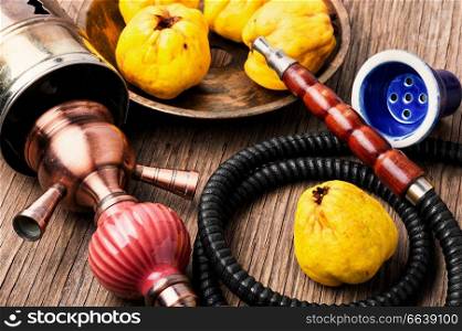 Oriental smoking hookah with mouthpieces with quince flavor.Shisha advertising. Asian hookah with aroma quince