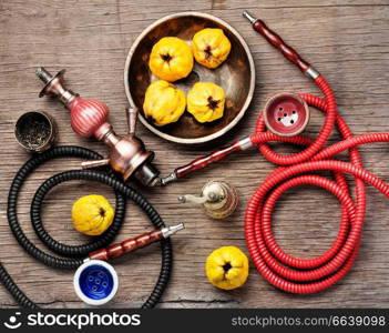 Oriental smoking hookah with mouthpieces with quince flavor.Shisha advertising. Turkish hookah with aroma quince