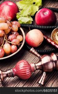 Oriental smoking hookah with taste of fruit mixture of grapes and apples.Shisha concept. Fruit taste of hookah.. Shisha with grapes and apples