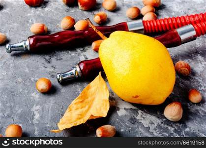 Oriental smoking hookah with two mouthpieces with pear flavor.Hookah advertising. Hookah with aroma pear