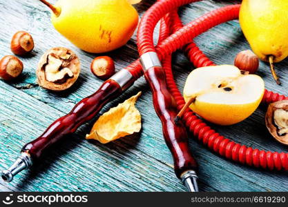 Oriental smoking hookah with two mouthpieces with pear flavor.Hookah advertising. Hookah with aroma pear
