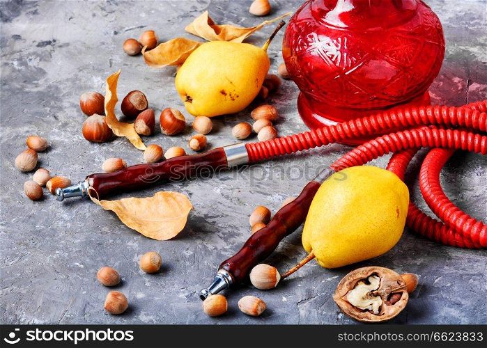 Oriental smoking hookah with two mouthpieces with pear flavor.Shisha advertising. Turkish hookah with aroma pear