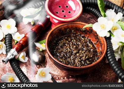 Oriental tobacco hookah with floral jasmine aroma. Smoke hookah with jasmine floral scent.Shisha concept.Modern hookah