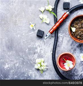Oriental tobacco hookah with floral jasmine aroma. Smoke hookah with jasmine floral scent.Shisha concept.Modern hookah