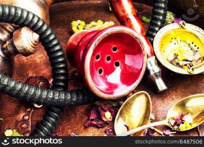 Oriental tobacco hookah with floral tea aroma. Smoke hookah with herbal floral tea.Shisha concept.Modern hookah