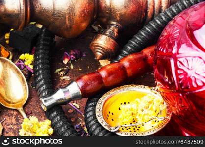 Oriental tobacco hookah with floral tea aroma. Smoke hookah with herbal floral tea.Shisha concept.Modern hookah