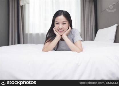 Oriental woman lying on the bed