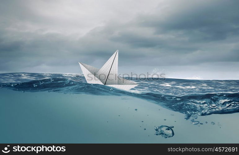 Origami boat. Boat made of paper sailing on blue water surface