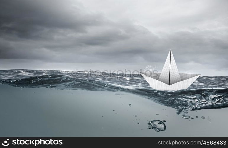 Origami boat. Boat made of paper sailing on blue water surface