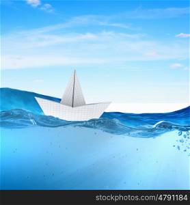 Origami boat. Boat made of paper sailing on blue water surface