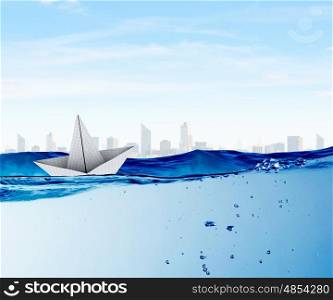 Origami boat. Boat made of paper sailing on blue water surface