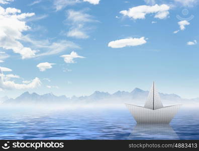 Origami boat. Boat made of paper sailing on blue water surface