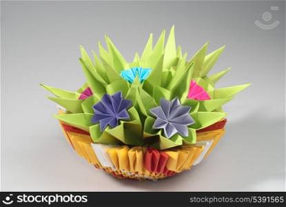 Origami bunch of various pink flowers isolated on grey