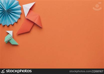 origami paper craft art dark orange surface