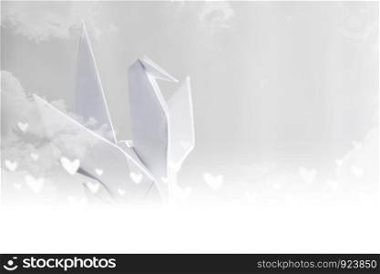 Origami paper crane on sky