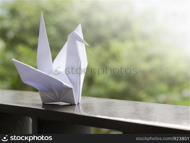 Origami paper crane on the balcony