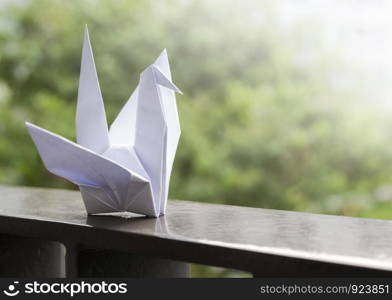 Origami paper crane on the balcony