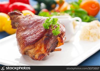 original German BBQ pork knuckle served with mashed potatoes and sauerkraut ,fresh vegetables on background,MORE DELICIOUS FOOD ON PORTFOLIO