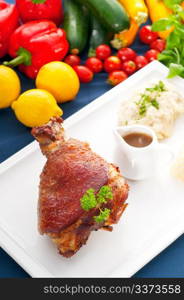 original German BBQ pork knuckle served with mashed potatoes and sauerkraut ,fresh vegetables on background,MORE DELICIOUS FOOD ON PORTFOLIO