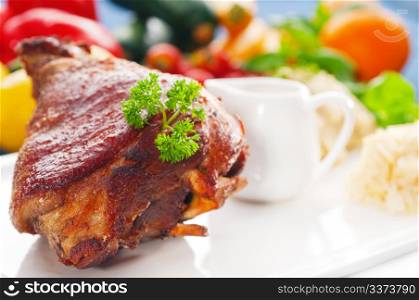 original German BBQ pork knuckle served with mashed potatoes and sauerkraut ,fresh vegetables on background,MORE DELICIOUS FOOD ON PORTFOLIO