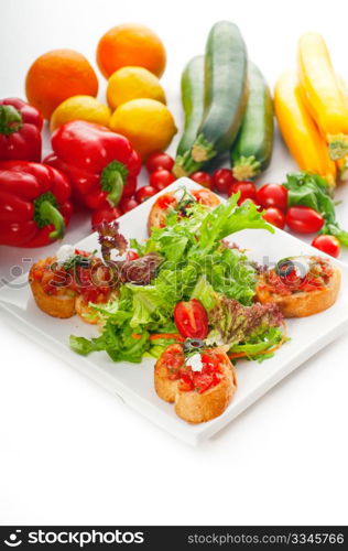 original Italian fresh bruschetta,typical finger food, with fresh salad and vegetables on background,MORE DELICIOUS FOOD ON PORTFOLIO