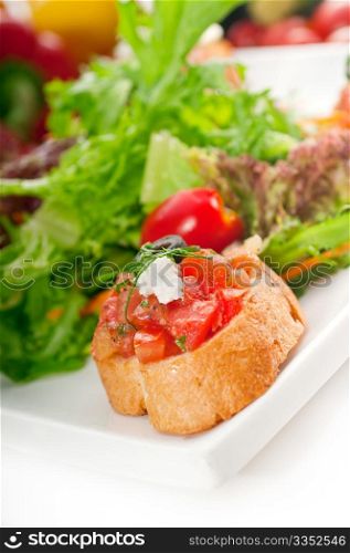 original Italian fresh bruschetta,typical finger food, with fresh salad and vegetables on background,MORE DELICIOUS FOOD ON PORTFOLIO